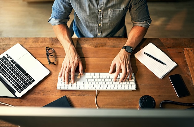 Imprenditore impegnato a digitare sulla tastiera del computer con le mani a tarda notte mentre si lavora per la pianificazione e il controllo della posta elettronica in un lavoro in ufficio Lavoratore aziendale produttivo che utilizza la tecnologia più recente