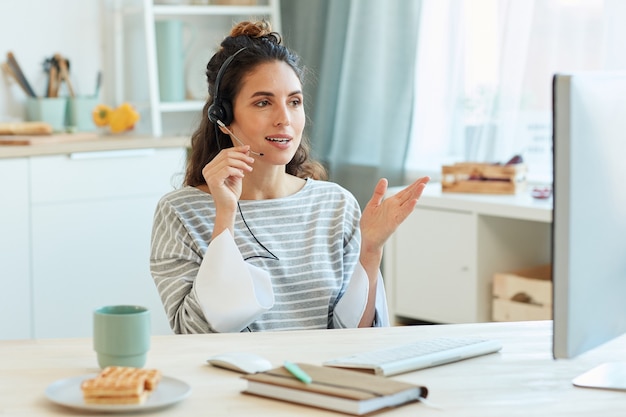 Imprenditrice moderna trascorre la mattina a casa a parlare con i suoi colleghi utilizzando l'app per videoconferenze