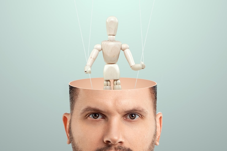 Photo in the man's head, instead of a brain, a puppet is a doll. the concept of addiction, slave, controlled person, tedious employee, clerk, office plankton.