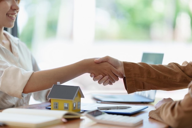 Incontro tra agenti e clienti e stretta di mano dopo un buon affare per l'acquisto di una casa Accordo e concetto immobiliare