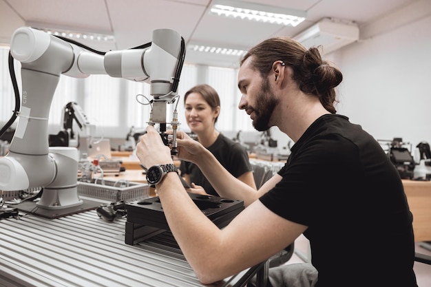industrial robotics program university students learning education mechanical assembly with robot universal training platform robot arm simulation model in engineering lab classroom