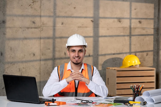 Ingegnere bel giovane ragazzo intelligente lavoratore civile in casco e giubbotto molto entusiasta del lavoro