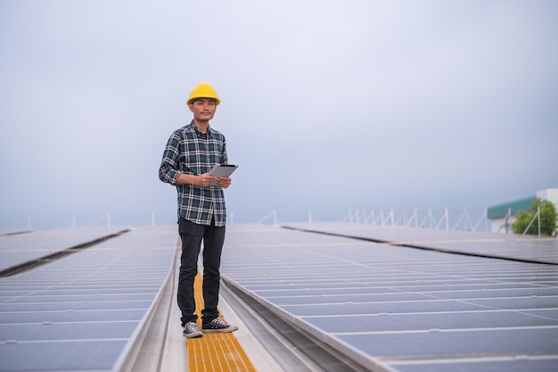 Ingegnere Chinses che controlla l'energia solare sul controllo del lavoro sul tetto della fabbrica per il sistema industriale