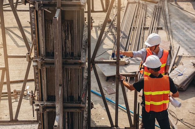 Ingegnere strutturale e caposquadra con progetti discutono del piano di ispezione dell'edificio