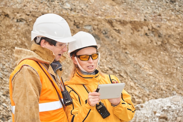 Ingegneri minerari che discutono la documentazione di lavoro all'aperto nel sito minerario