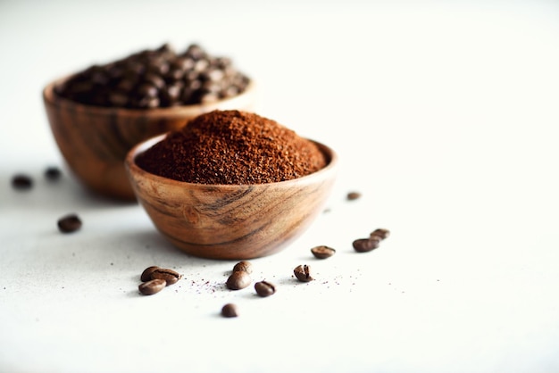 Ingredienti per fare la bevanda alla caffeina chicchi di caffè macinati e caffè istantaneo su sfondo in cemento chiaro spazio copia Banner