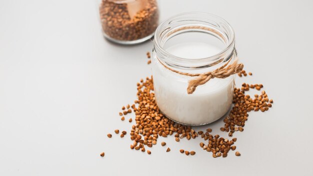 Ingredienti per latte di grano saraceno vegano fatto in casa in vasetto di vetro prodotto caseario alternativo nessuna allergia