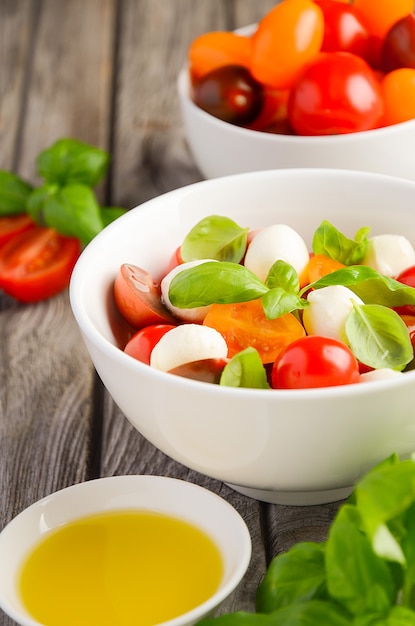 Insalata caprese italiana con pomodorini, mozzarella e basilico fresco