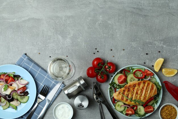 Insalata con pollo alla griglia su tavola grigia