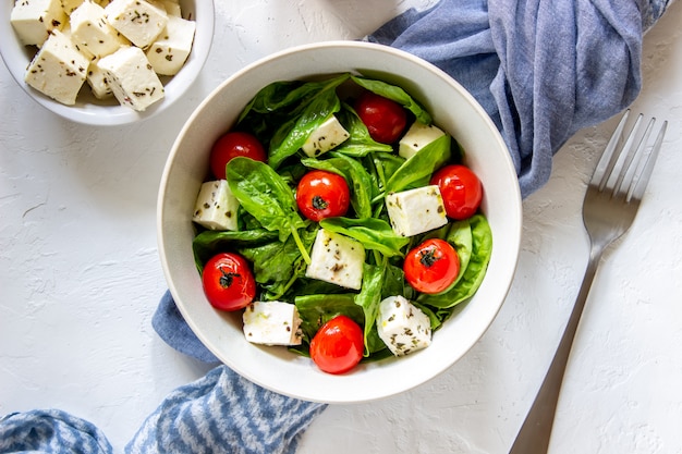 Insalata con pomodori, spinaci e formaggio.