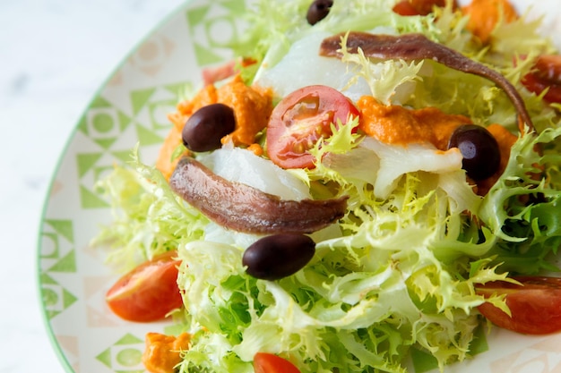 Insalata di baccalà con acciughe e scarola