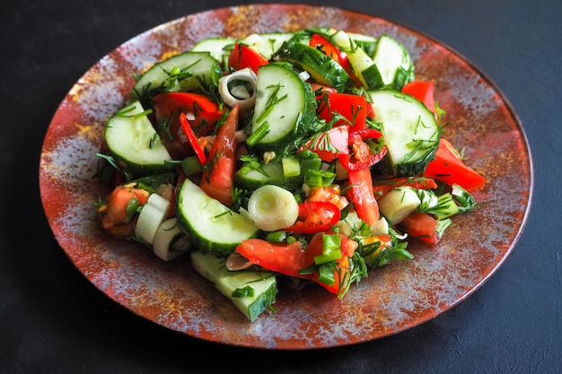 Insalata di cetrioli e pomodoro con peperoncino e cipolle verdi condite con olio d'oliva.