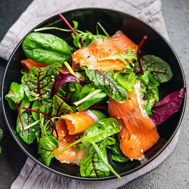 Insalata di salmone fette di pesce insalata verde mix foglie frutti di mare fresco pasto sano cibo dieta spuntino