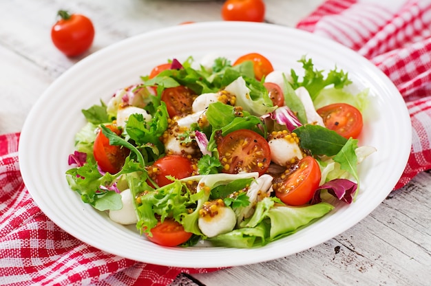 Insalata dietetica con pomodori, lattuga di mozzarella con condimento miele e senape