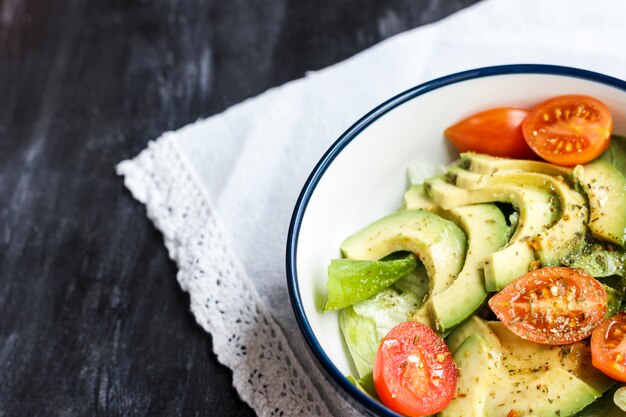 Insalata vegetariana con avocado, rucola, pomodorini ed erbe aromatiche.