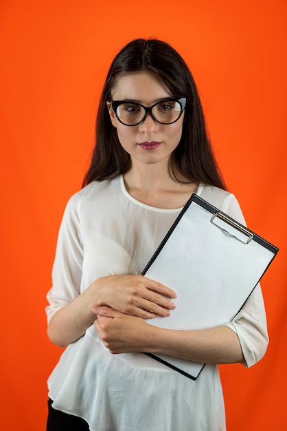 Insegnante di scuola in abiti da lavoro in piedi con tablet su sfondo isolato in studio