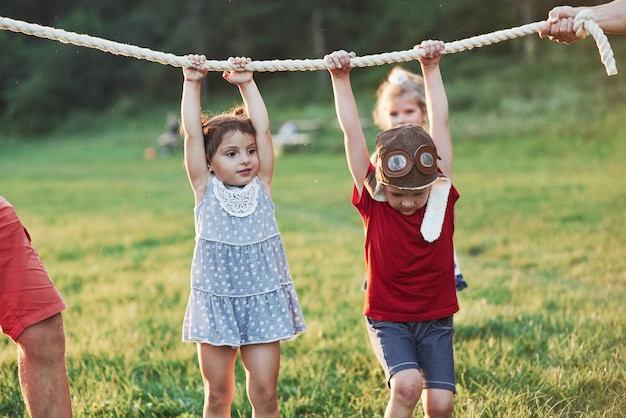 Interessante quanto di noi papà riesce a tenere su quella corda. Tirare un gioco di corde sta andando così divertente. Quello è che sembra avere buoni genitori che amano la natura e l'azione