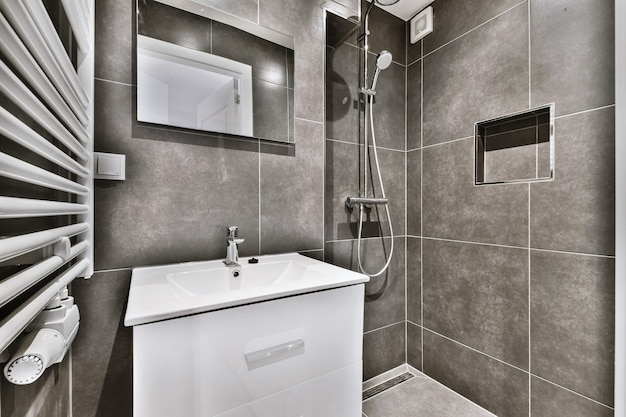 Interior design di un bel bagno con elegante rubinetto e specchio