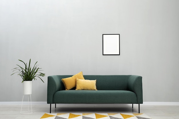 Interni eleganti con comodo divano e pianta d'appartamento
