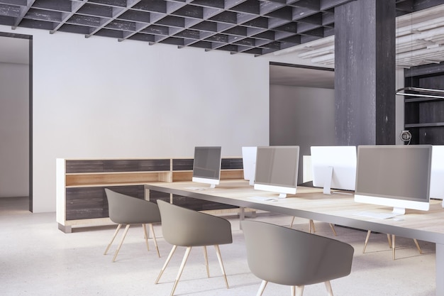 Interni moderni per uffici di coworking in cemento e legno con spazio vuoto sulla parete, schermi di computer vuoti, mobili per apparecchiature e rendering 3D di luce diurna