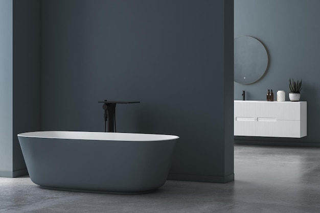Interno del bagno moderno e minimalista, mobiletto del bagno moderno, lavabo bianco, specchio ovale, cemento