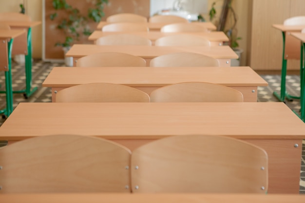 Interno dell'aula vuota con le sedie e gli scrittori di fila