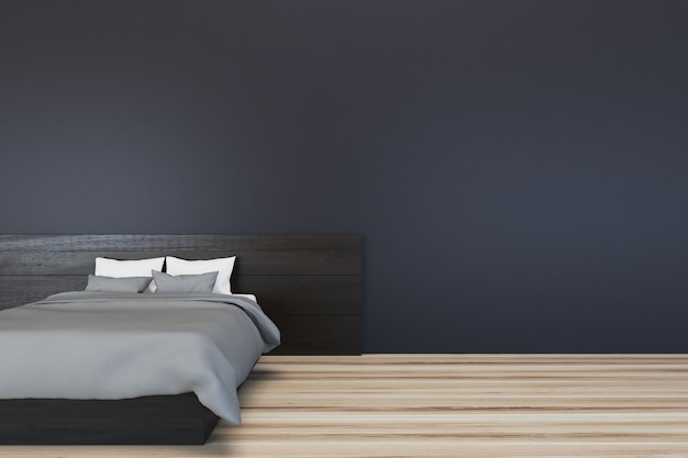 Interno di camera da letto minimalista con pareti nere e un letto principale grigio su un pavimento in legno.