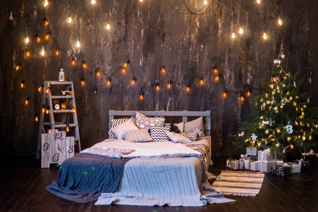 Interno di Natale in colore scuro con letto e ghirlande