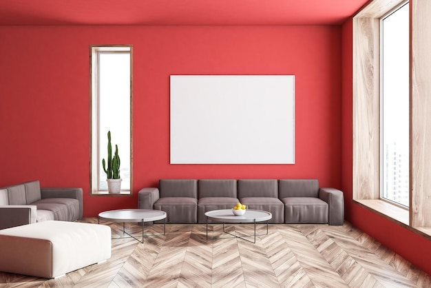 Interno di un ampio soggiorno con pareti rosse, pavimento in legno, due divani grigi in piedi vicino a tavolini rotondi e poster orizzontale. Rendering 3d mock up