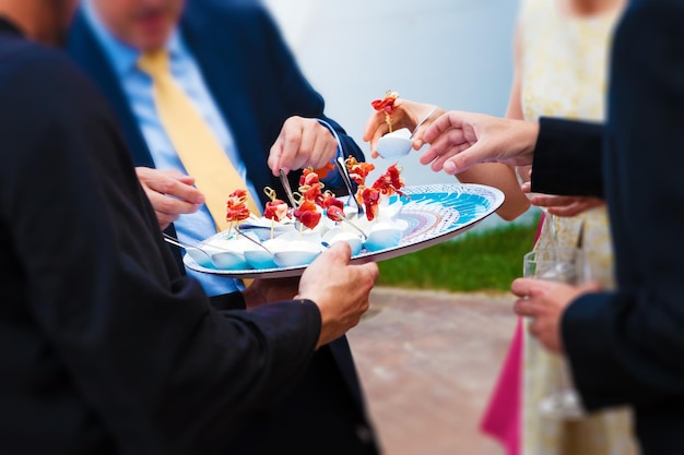 Invitati al matrimonio che mangiano un antipasto