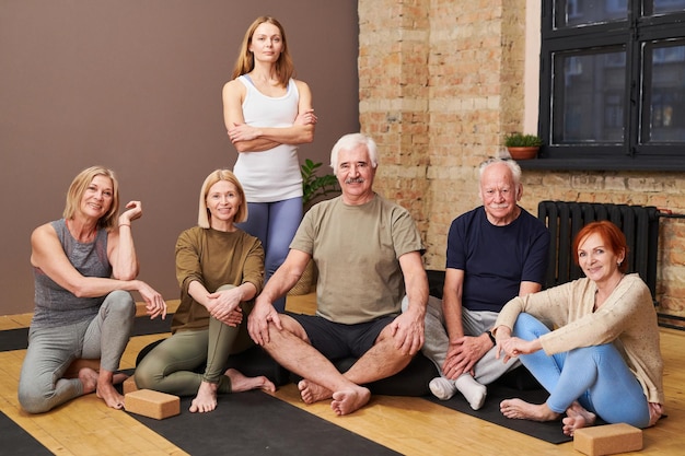 Istruttore di fitness che addestra persone anziane nel club