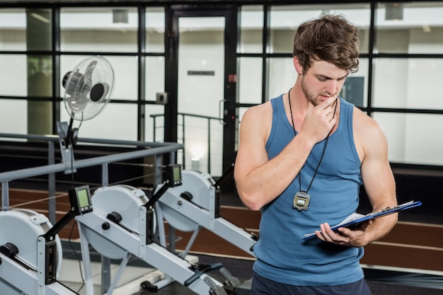 Istruttore di palestra che esamina gli appunti