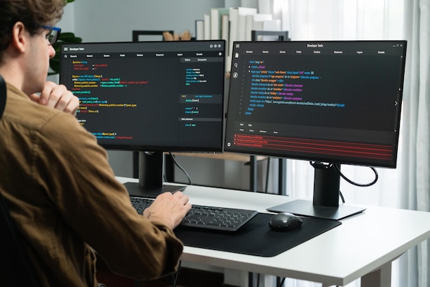 it developer working online software development coding on pc screens gusher