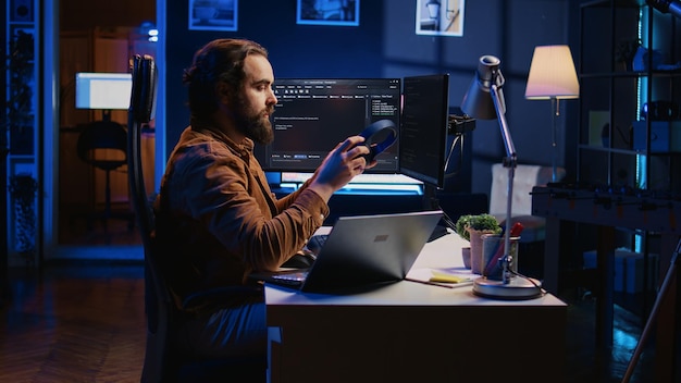 it expert doing multitasking in home office listening music drinking coffee