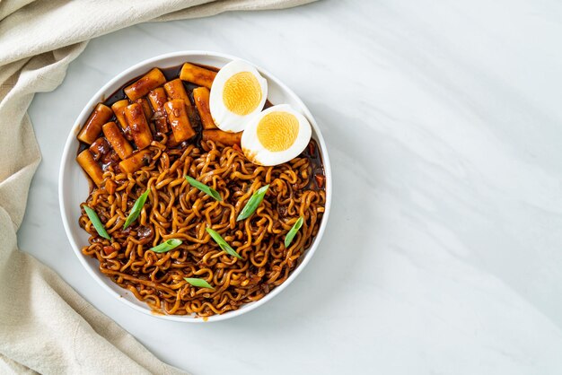 Jjajang Rabokki Spaghetti istantanei coreani o Ramyeon con torta di riso coreana o Tteokbokki e uovo in salsa di fagioli neri