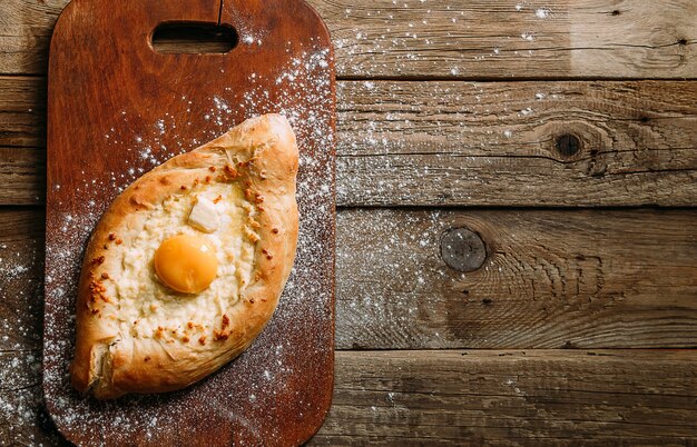 Khachapuri in Adzharian con formaggio Adyghe, formaggio e tuorlo. Cibo tradizionale caucasico