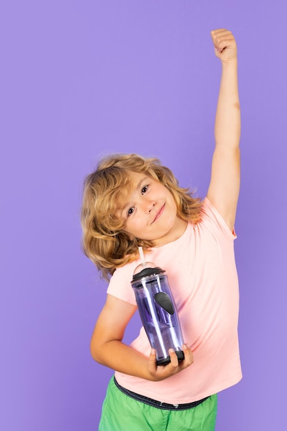 Kid acqua potabile isolato su sfondo studio Ritratto di bambino con un bicchiere di acqua dolce