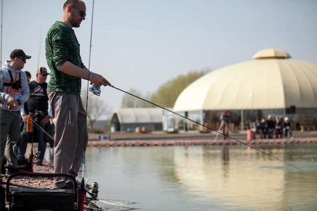 Kiev, Ucraina, 16 aprile 2018. Il pescatore caucasico cattura il pesce con una canna da spinning sul lago.