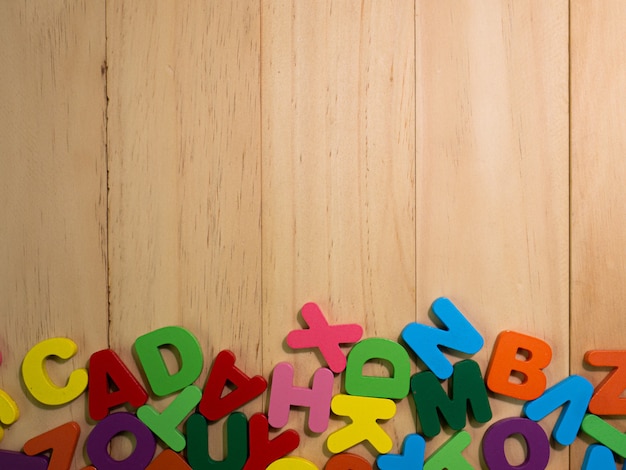 L'alfabeto in legno multi colore sul tavolo per l'istruzione o il concetto di bambino