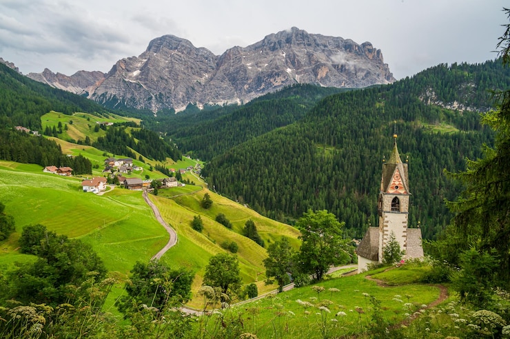 Foto l'antica chiesa di santa barbara in posizione panoramica a la val, in val badia, nel cuore delle dolomiti