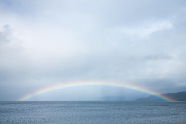 L'arcobaleno sul mare contro il cielo nuvoloso