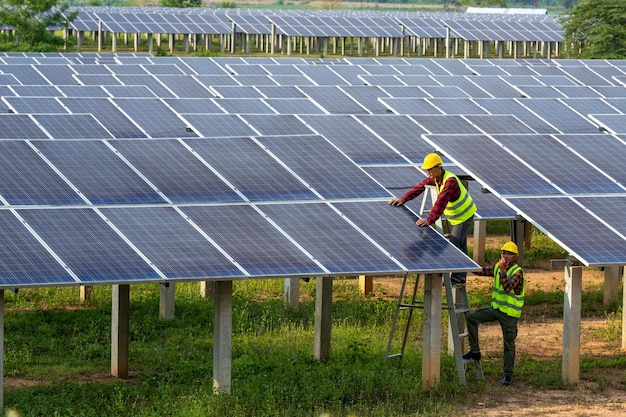 L'elettricista del team asiatico che installa pannelli solari che lavora su fonti di energia alternative pulisce l'energia solare