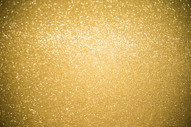 L'oro luccica sullo sfondo sfocatura luccicante luci spot Bokeh Sfondo chiaro oro lucido