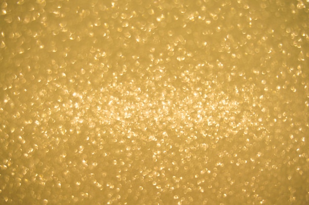L'oro luccica sullo sfondo sfocatura luccicante luci spot Bokeh Sfondo chiaro oro lucido