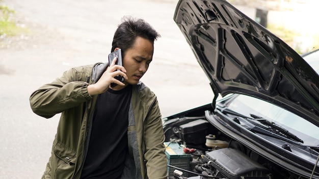 L'uomo asiatico ha aperto il cofano dell'auto durante la chiamata