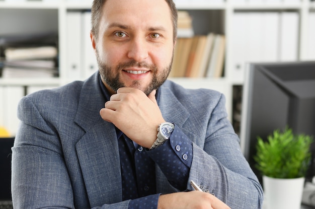 L'uomo barbuto sorridente bello in ufficio guarda a porte chiuse con la cartella nel fondo. La visita moderna del treno della vettura di idea del rapporto dell'istituto universitario del laureato di stile di vita del colletto bianco fa il concetto della nota