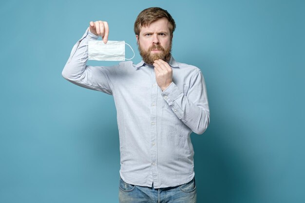 L'uomo caucasico è dispiaciuto perché una barba ispida creerà problemi quando indossa una maschera medica