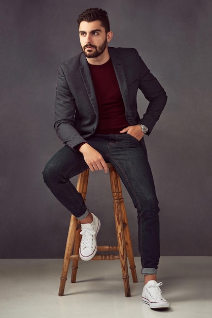 L'uomo che pensa e si fida in studio per lo stile di moda e l'estetica misteriosa gentiluomo abbigliamento di designer e sogno di giorno su sfondo scuro con orologi di lusso gusto costoso o seduto su una sedia