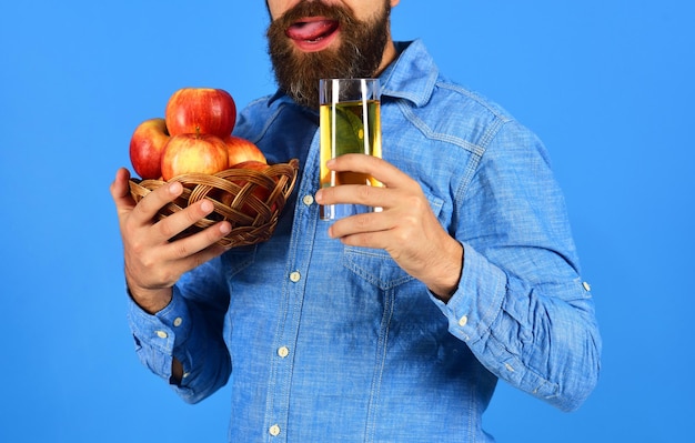 L'uomo con la barba tiene una ciotola di frutta e succo di frutta