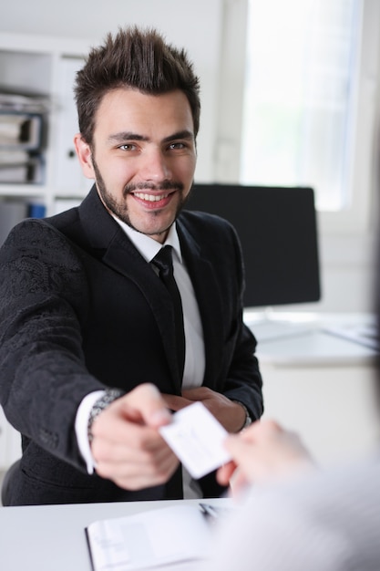 l'uomo dà il biglietto da visita in ufficio